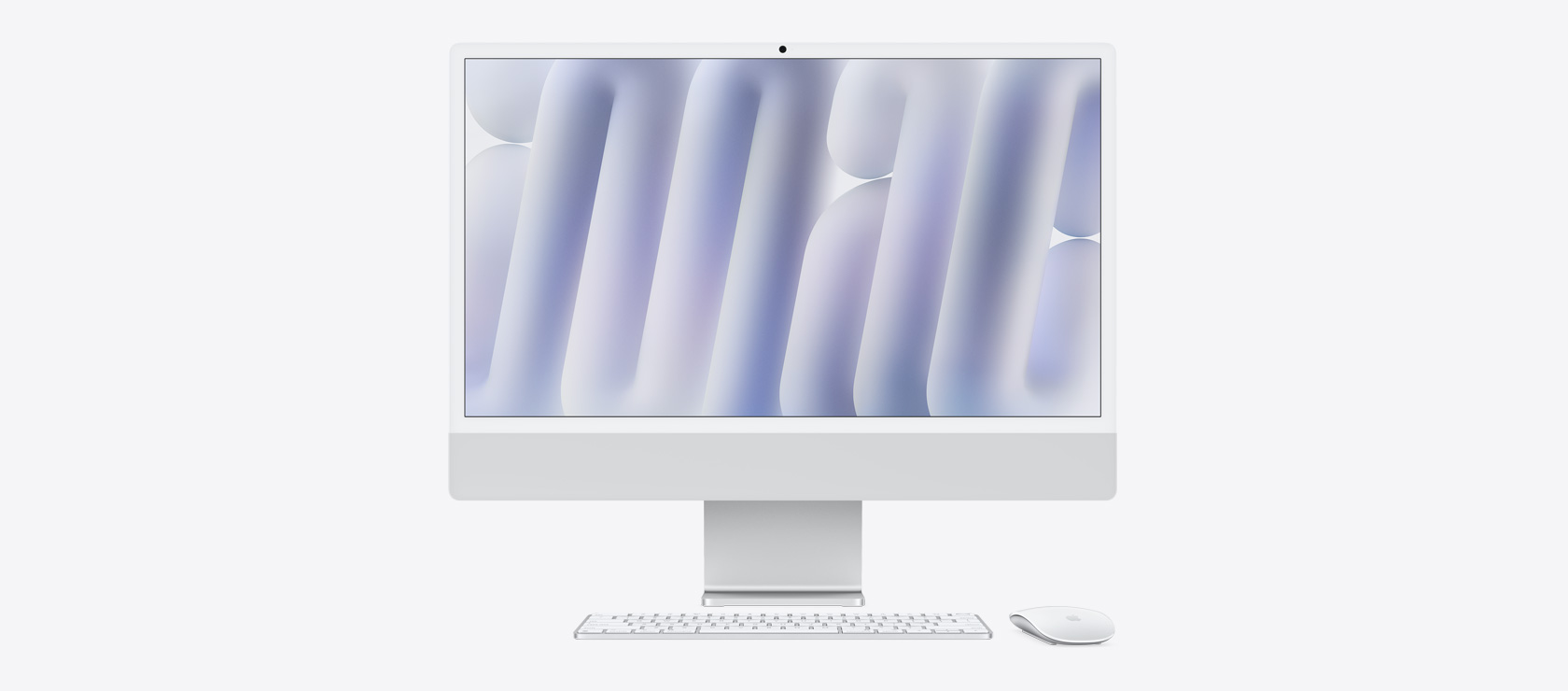 Vista frontal de una iMac color plata con mouse y teclado a juego